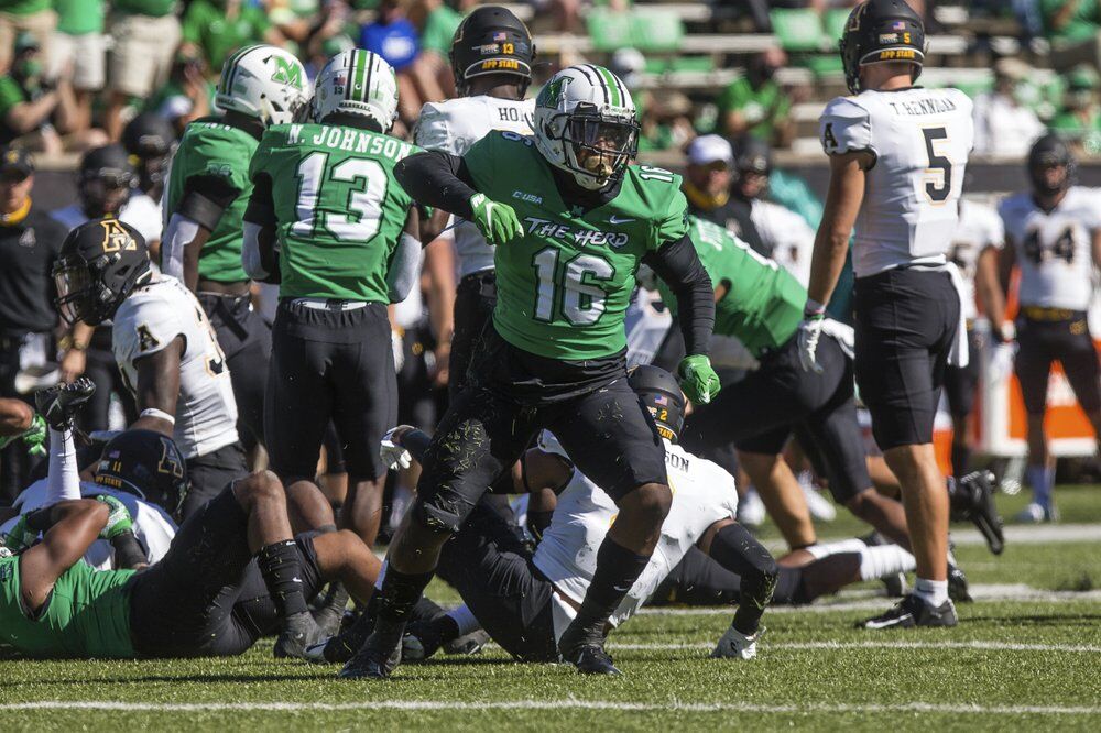 Marshall linebacker Brian Cavicante (16) celebrates